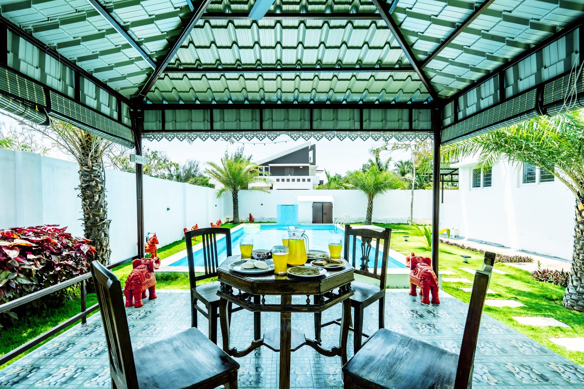 Table set for breakfast under the pavilion by the pool