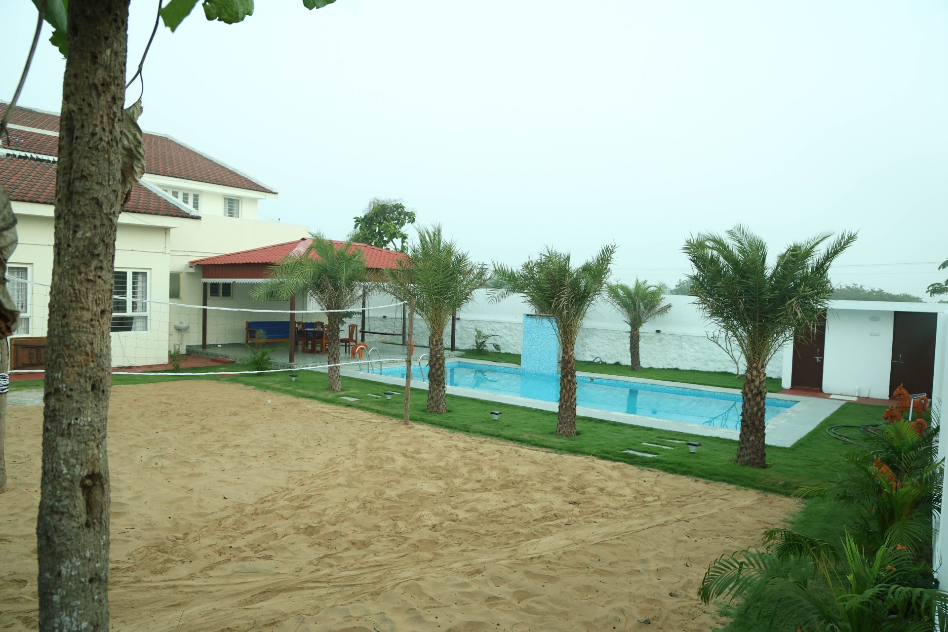 Sand volleyball court beside the pool