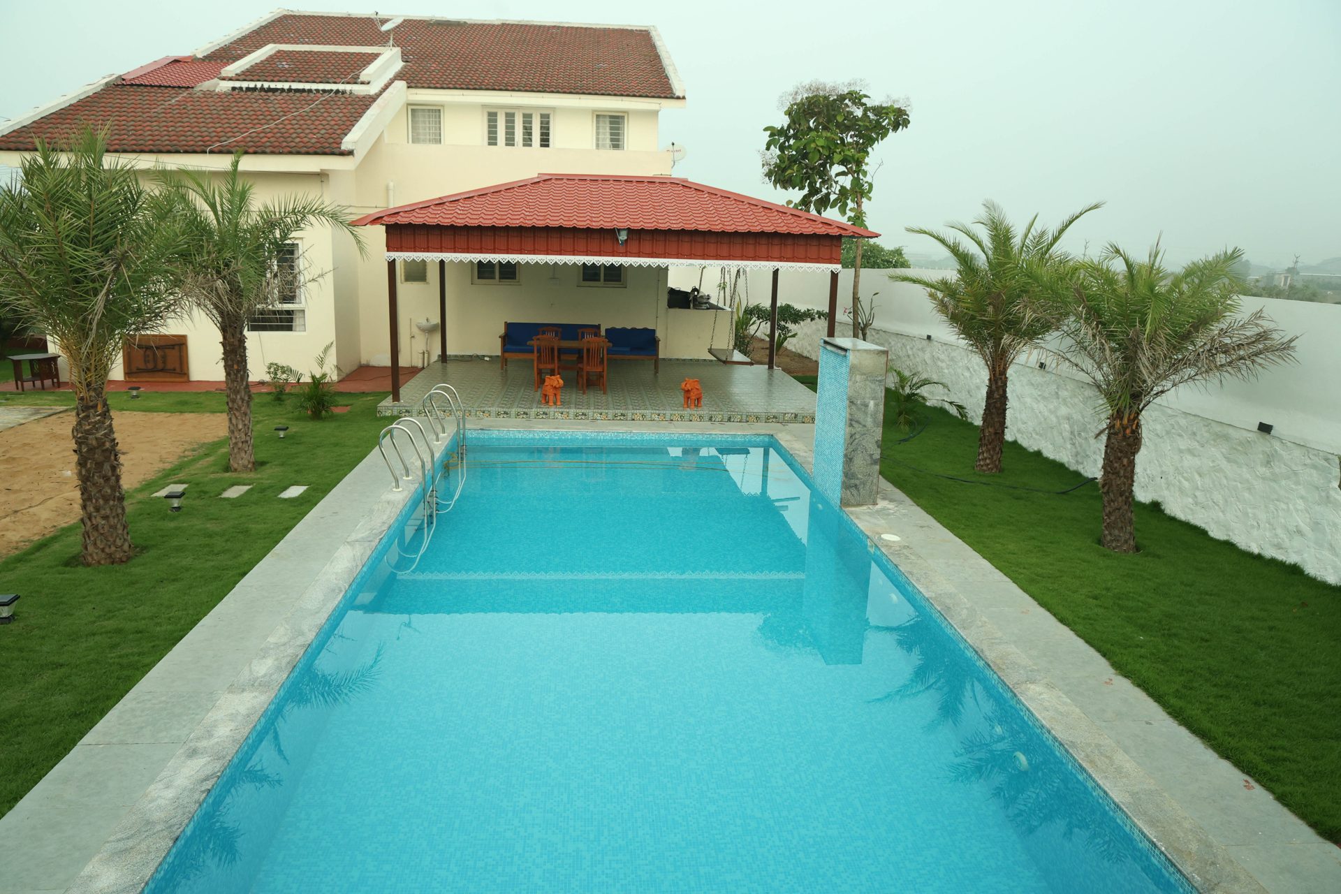 Pool alongside the covered outdoor dining pavilion